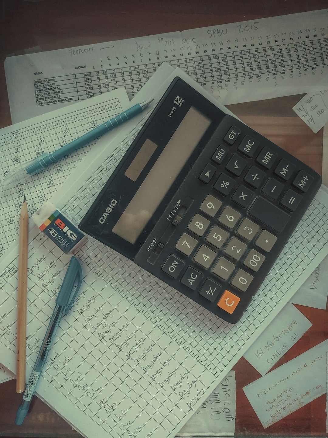 about-01 a-calculator-sitting-on-top-of-a-pile-of-papers-741ishluyhk